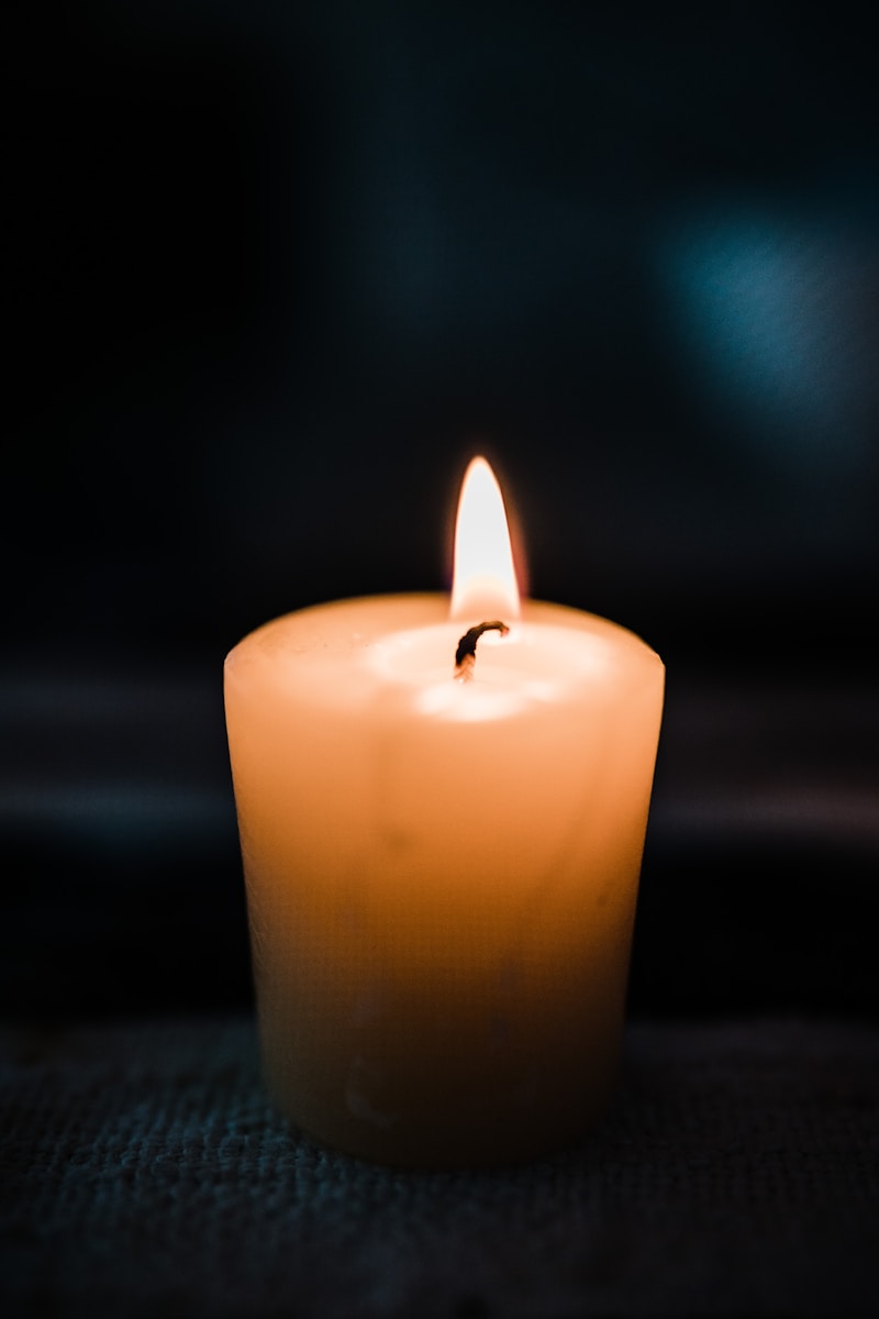 a lit candle on a table